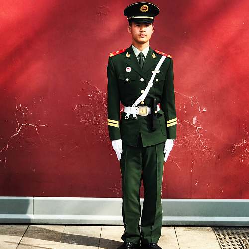 human man standing near red wall people
