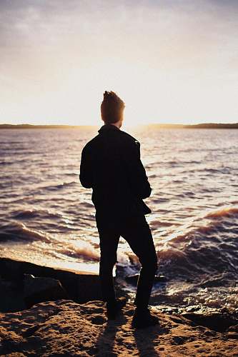 people man standing near seashore human