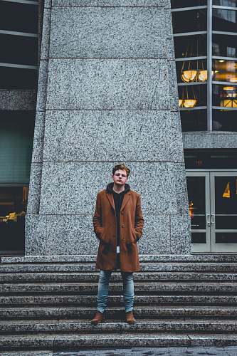 human man standing next to stairs and building people