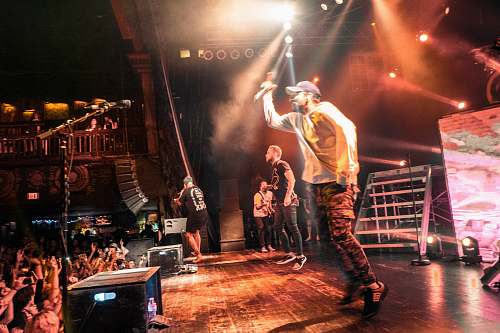 people man standing of stage and holding microphone human