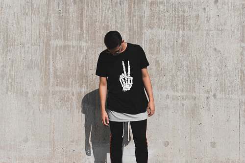 people man standing while looking down at daytime shirt