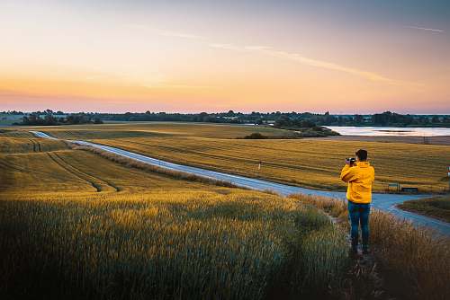 human man taking photo of grassland people