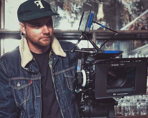 human man taking video using studio camera people