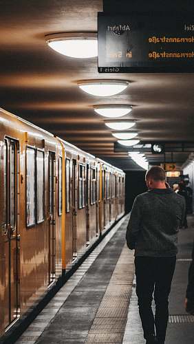 train man walking near subway train train station