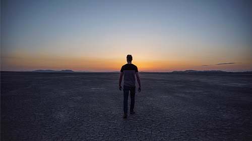 human man walking on desert people