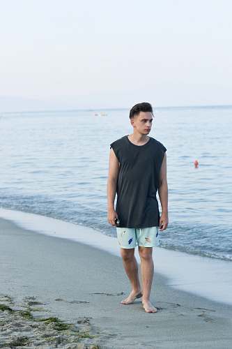 human man walking on shore people