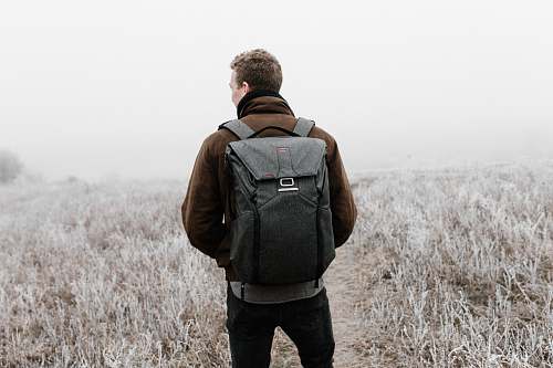 people man wearing backpack walking on pathway human