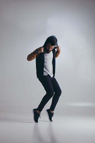 human man wearing black hooded jacket people
