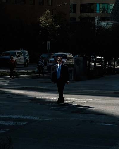 human man wearing black suit jacket and blue necktie people