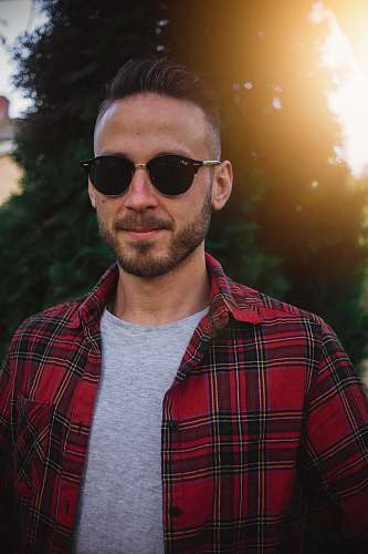 human man wearing black sunglasses and plaid shirt people