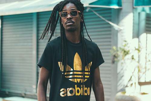 people man with dreadlocks hair wearing black and gold Adidas crew-neck shirt human