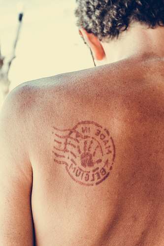 human man's shoulder with tattoo people