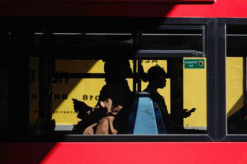people people inside bus sitting while using smartphone human
