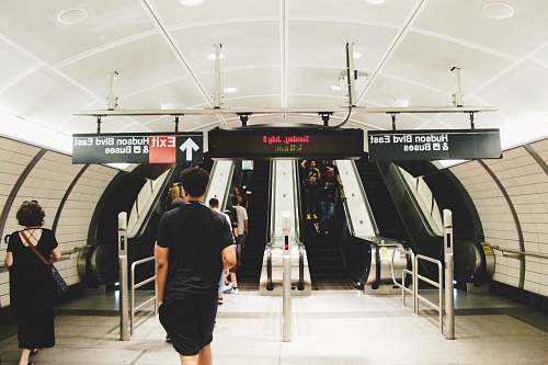 people people walking towards escalator inside Bus station human