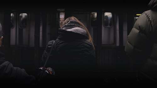 people person in black coat standing in front of white panel door human