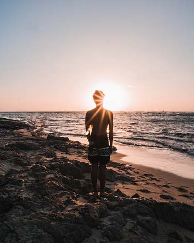 human person in black shorts standing on stone people