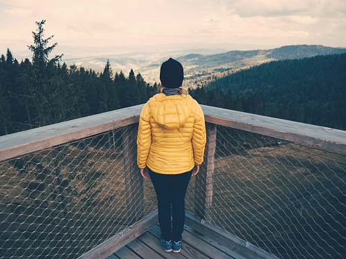 people person standing facing towards overview trees and mountains human