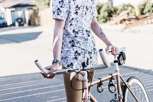 bike person standing while holding bike bicycle