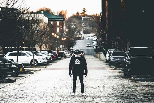 people person wearing jacket and helmet on road human