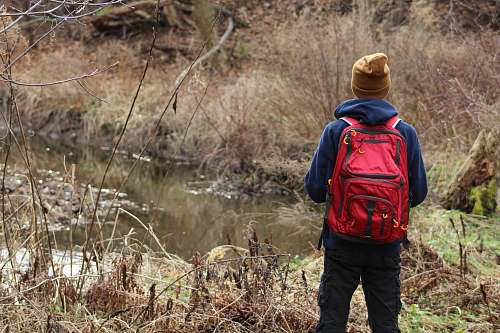 human person wearing jacket looking at river people