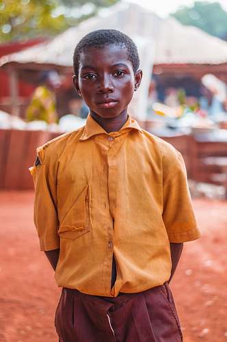 human selective focus photo of boy standing people