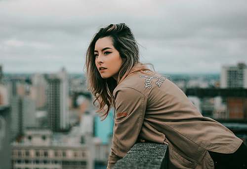people selective focus photo of woman standing on building rooftop during daytime human