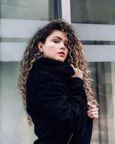 people selective focus photography of woman holding coat human