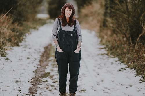 human shallow focus photo of woman walking on snow people