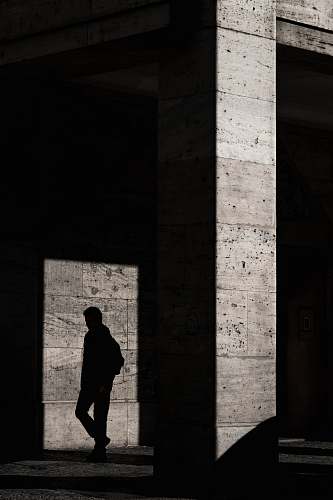 human silhouette of man standing inside structure people