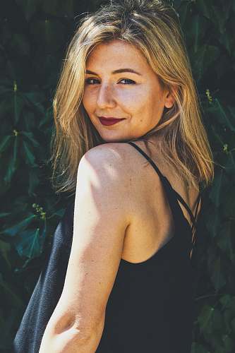 human smiling woman wearing black spaghetti strap top people