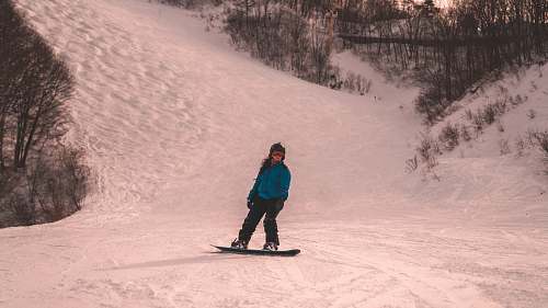 people snowboarder standing on snow covered mountain human