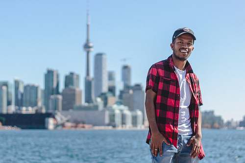 people standing man taking selfie beside CN Tower, Canada human