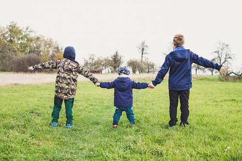 human three children holding hands standing on grasses people