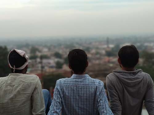 people three man sitting on top of building human