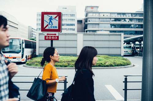 human three people walking beside metal rails people
