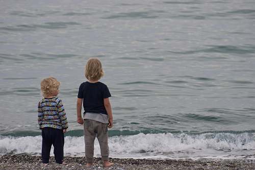 human two child standing on shore people
