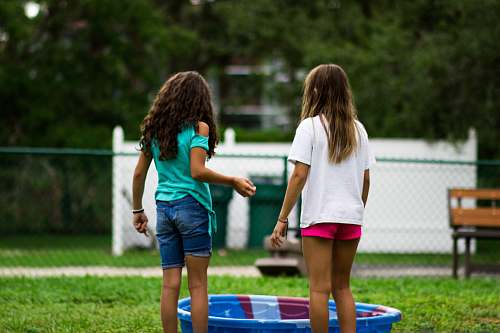 people two girls near round blue plastic basin human