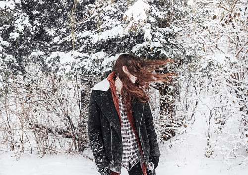 people woman facing sideways with hair covering her face snow