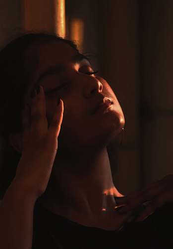 people woman holding her head on dark human