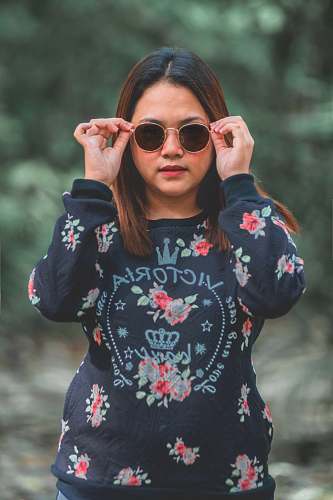 human woman holding her sunglasses people