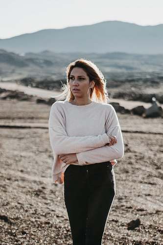 human woman in beige top and black tops on brown soil during daytime people