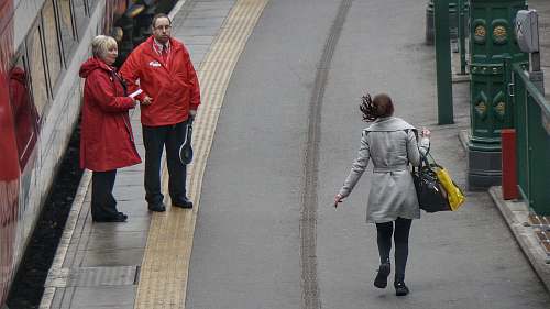 people woman in gray coat walking on the road during day time human