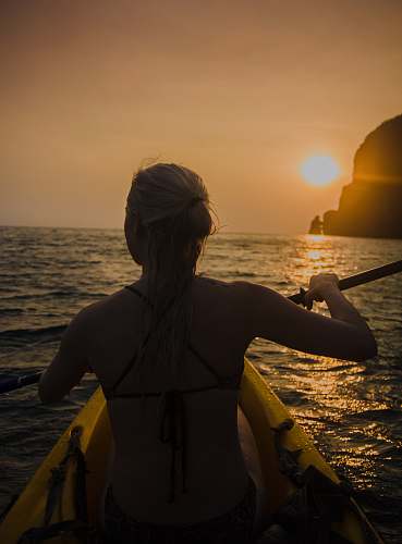 people woman kayaking facing sunset human