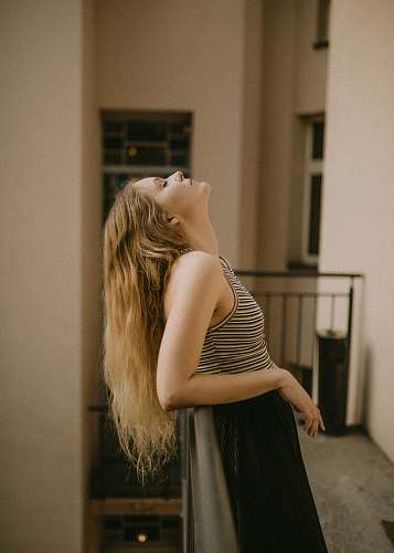 people woman leaning backwards into metal railing human