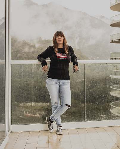 people woman leaning on glass wall human