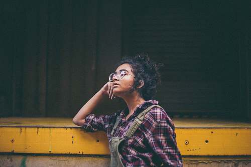 people woman leaning on yellow surface human