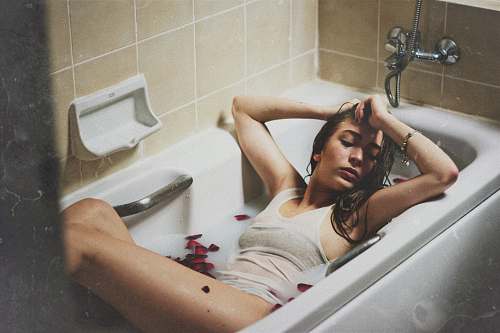 people woman lying on bathtub tub