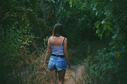 people woman on pathway between trees human
