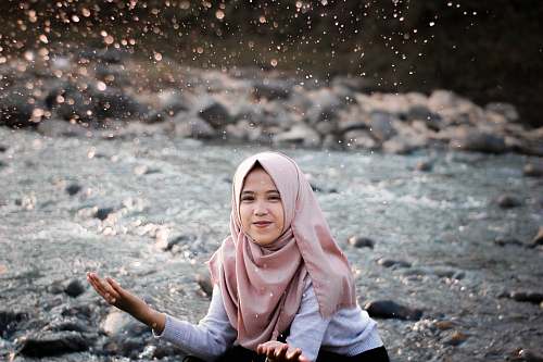 people woman playing with water on river human