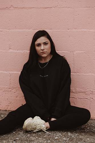 human woman sitting near wall people